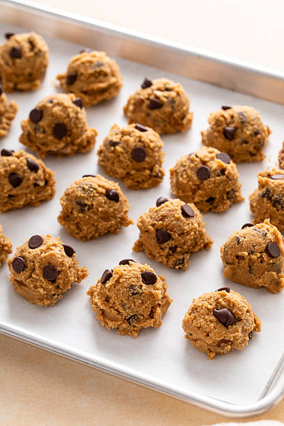 istock Chocolate chip cookies with pecan nuts, cookie dough ready on a baking sheet 2209429855