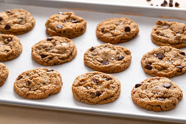 istock Chocolate chip cookies with pecan nuts, freshly baked cookies on a baking sheet 2209429856