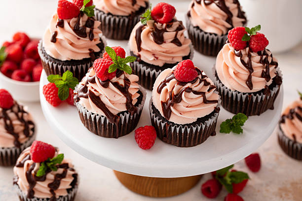 istock Raspberry chocolate cupcakes with raspberry buttercream frosting a drizzle of chocolate glaze 2209429867