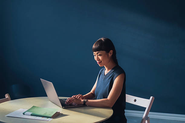 istock Young Professional Woman Working on a Laptop in a Cozy Workspace 2209432108