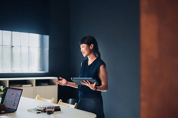 istock Businesswoman Presenting Ideas During a Modern Office Meeting 2209432120