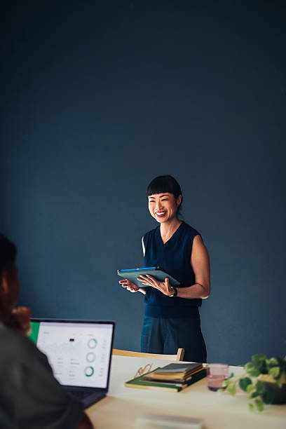 istock Confident Businesswoman Giving Presentation in Professional Office Setting 2209432121