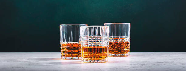 istock Blended Scotch whiskey glasses on dark green background 2209433939
