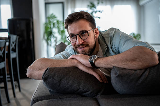 istock Young man relaxing on sofa at home, enjoying peaceful moment 2209435061
