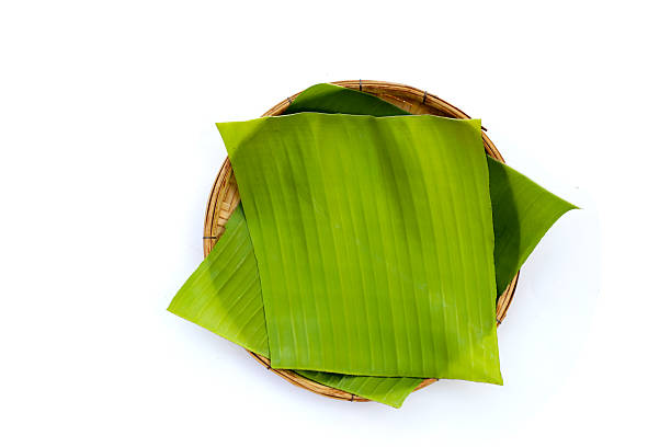 istock Banana leaves in bamboo weave plate on white background. 2209435756