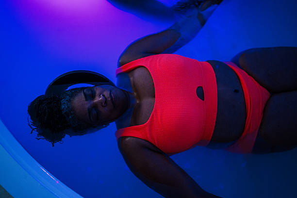 Black woman enjoying hydrotherapy float session at spa