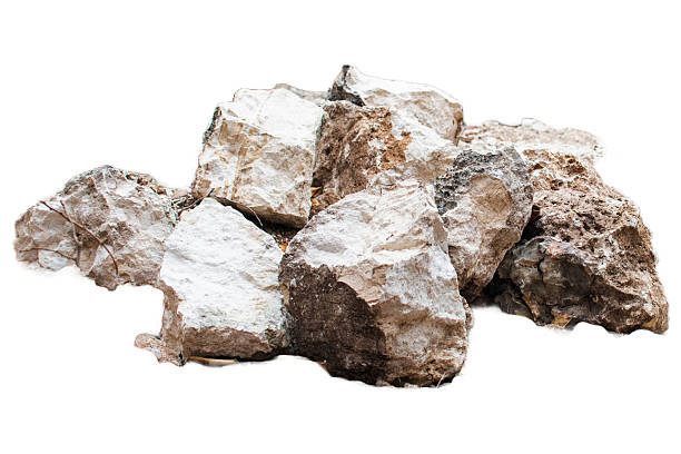 A close-up of a pile of stones in varying sizes and shades of white, brown, and gray. The rough, unpolished textures evoke a raw, natural aesthetic and highlight the organic beauty of minerals.