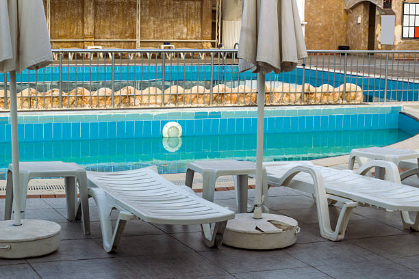 istock Swimming Pool With Loungers 2209444873