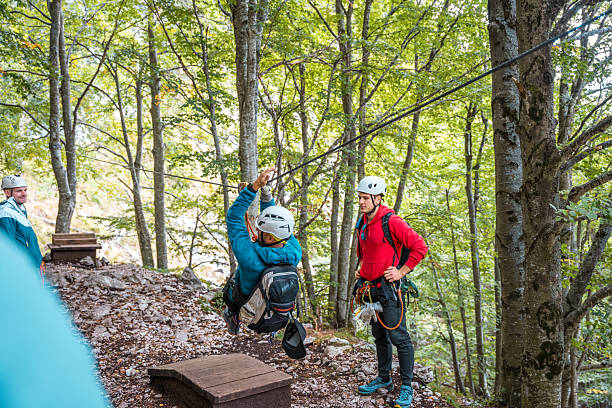 istock Diverse Group of Adventurers on a Zip Line Course with Instructor 2209452967