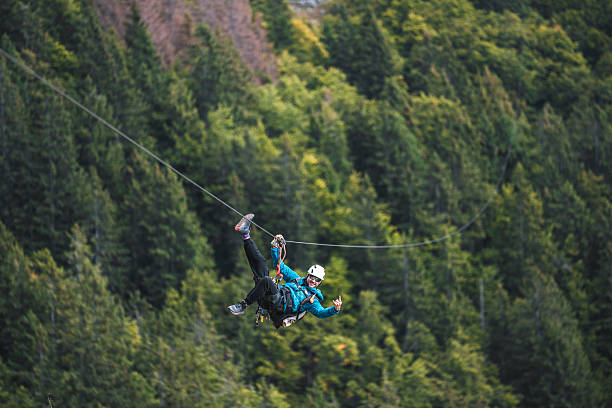 istock Adventurous Male Zip Line Enthusiast in Forest Setting 2209452971