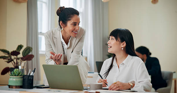 istock Business women, laptop and teamwork in office for advice, training and problem solving. Administration, female manager and tech in agency for feedback, help and assistance with learning software 2209456957