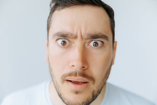 Man showing surprise and curiosity with intense expression in bright setting
