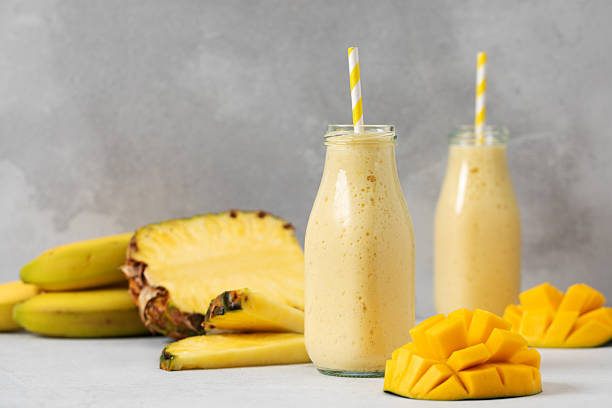 istock Refreshing tropical smoothie with mango, pineapple, and banana for a summer beverage delight 2209461840