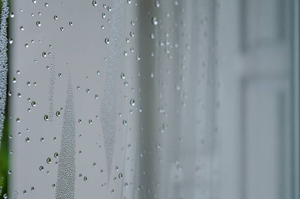 istock rain drops during raining in rainy day outside window glass with blurred background with water droplet flow down the surface 2209468004