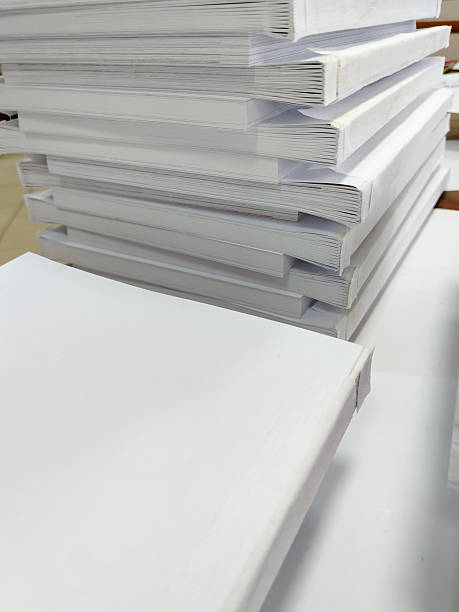 istock Close-up, a stack of glued book blocks prepared for binding in a printing house, vertical 2209469966