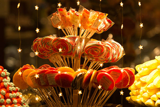 Sweet Treats on Display in a Shop Window at Night.