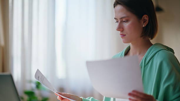istock Stressed accountant worried work mistake reading documents at workplace closeup. 2209473202