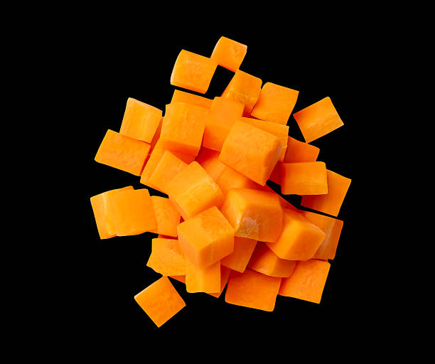 istock Top view of orange carrot slices in cube shape in stack isolated on black background with clipping path 2209473409