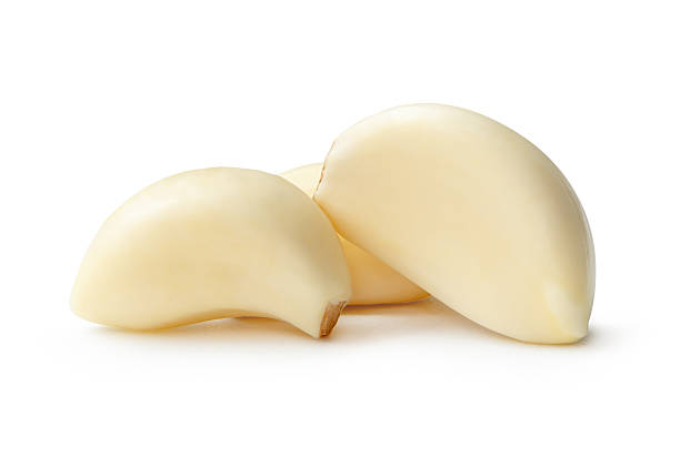 istock Side view of three white peeled garlic cloves or pieces in stack isolated on white background with clipping path 2209474840