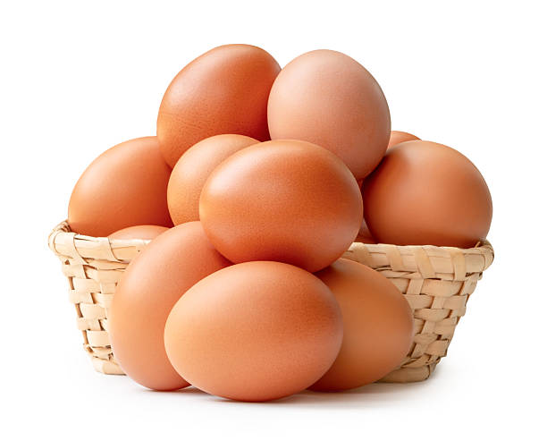 istock Many raw brown chicken eggs in stack in wicker basket isolated on white background with clipping path 2209475122