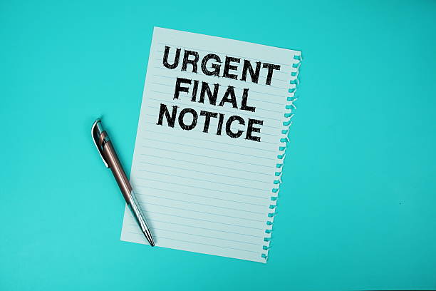 istock Urgent Final Notice text written on paper with pen flat lay on blue background 2209475760