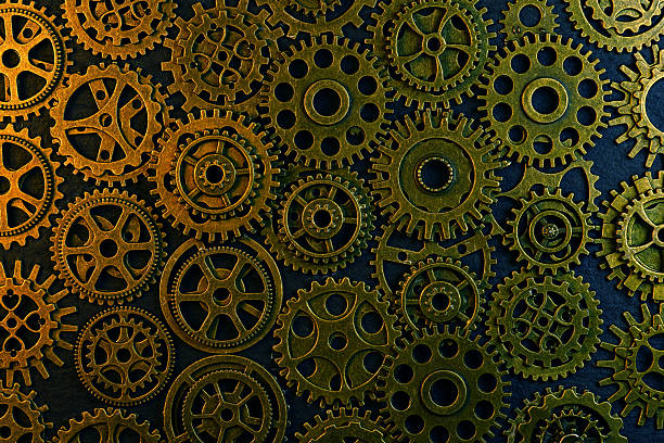 istock Cogs and gear wheels arranged on slate rock background showing textures and patterns in engineering metal work 2209481474
