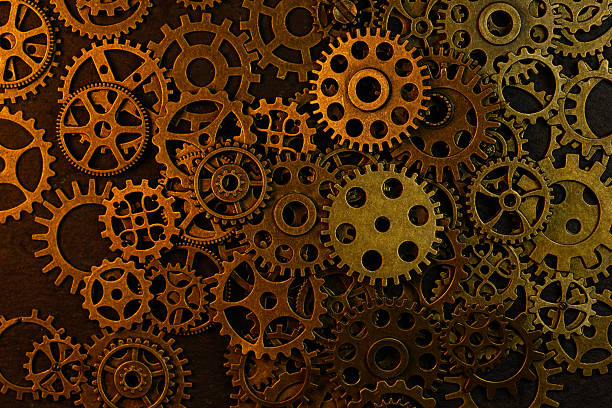 istock Cogs and gear wheels arranged on slate rock background showing textures and patterns in engineering metal work 2209481500