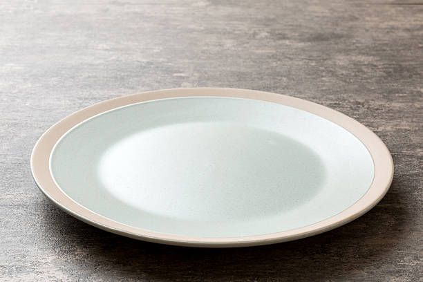 istock Perspective view of empty light plate on cement background. Empty space for your design 2209485812