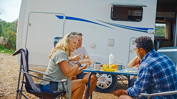 istock Diverse Friends Enjoying Breakfast Outdoors at Seaside Camping Spot with Camper Van 2209487062