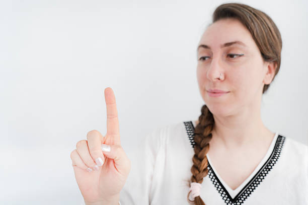 woman pressing a virtual button with her index finger on white background