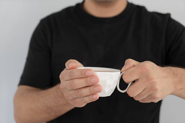 istock Close-up man hand holding coffee cup 2209488042