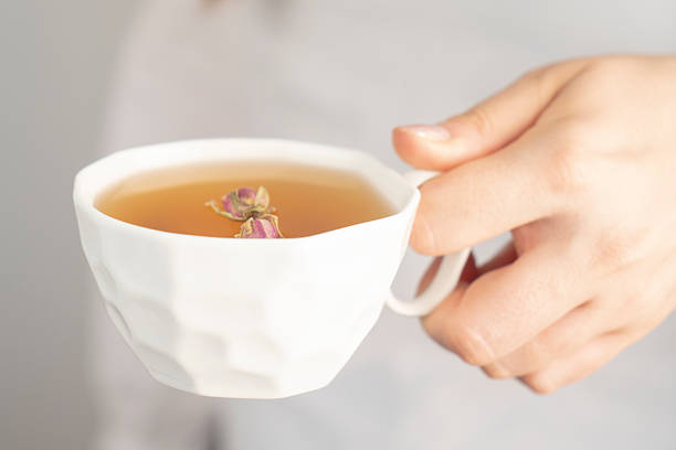 Female hand holding cup of herbal tea. close up