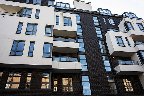 istock Modern apartment building facade with glass windows and balconies 2209489913