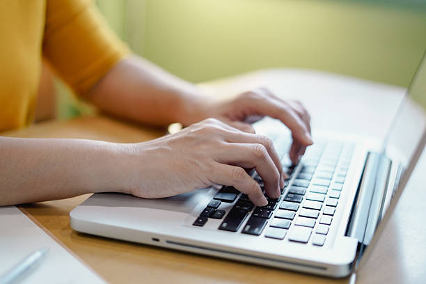 istock Female hands typing on keyboard to work on laptop at home. 2209490117
