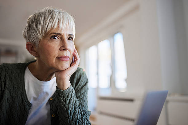 istock Mature woman day dreaming at home. 2209490342