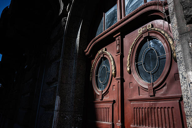 Painted double doors with circular windows and decorative golden details under natural light