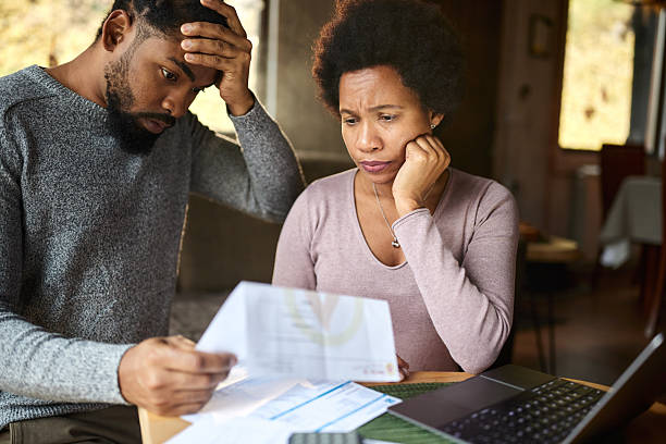 istock Worried black couple having problems with their financial bills at home. 2209492801
