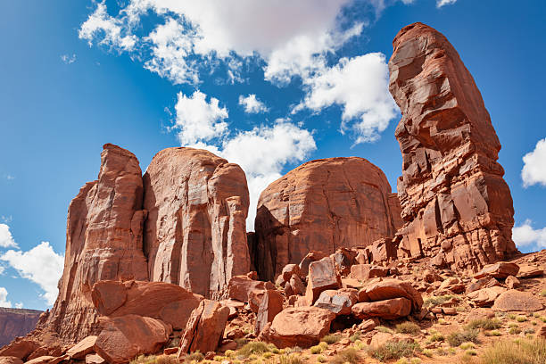 The Thumb Monument Valley Rock Formation. Protruding Rock at the Corner of Camel Butte in Monument Valley under beautiful summer sky with cumulus clouds. Majestic Rock Formation Landscape in Monument Valley, Arizona - Utah, USA, North America.