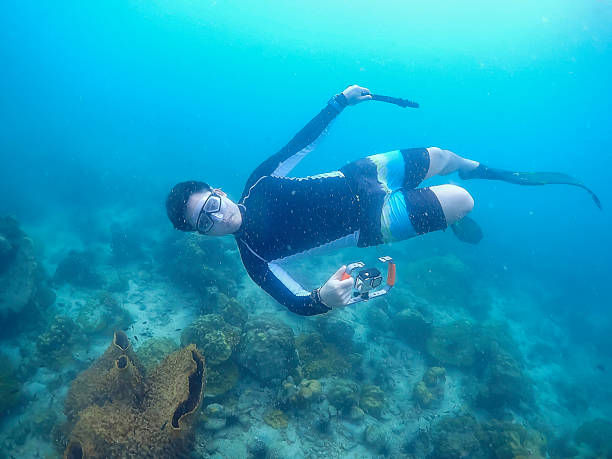 istock Freediver Swimming in Deep Sea DIver Eploring Sea Life. 2209495010
