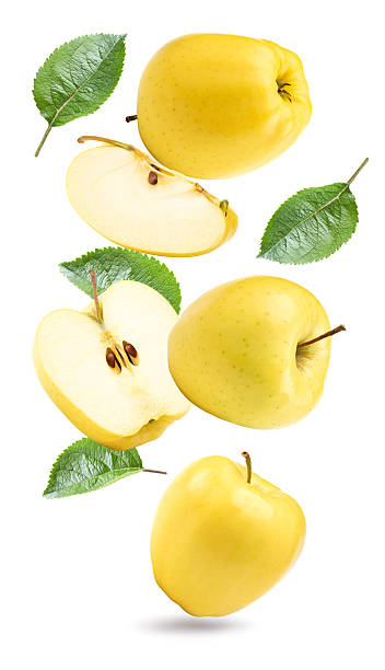 istock flying yellow apples with green leaf and slices isolated on a white background. clipping path 2209495132