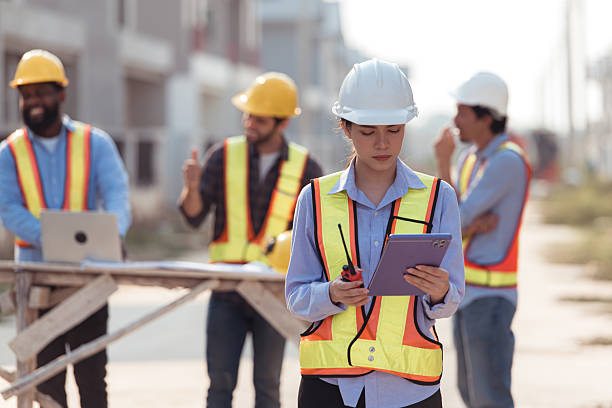 istock Group of architects and engineers work together to assess the residential home construction site's progress 2209497357