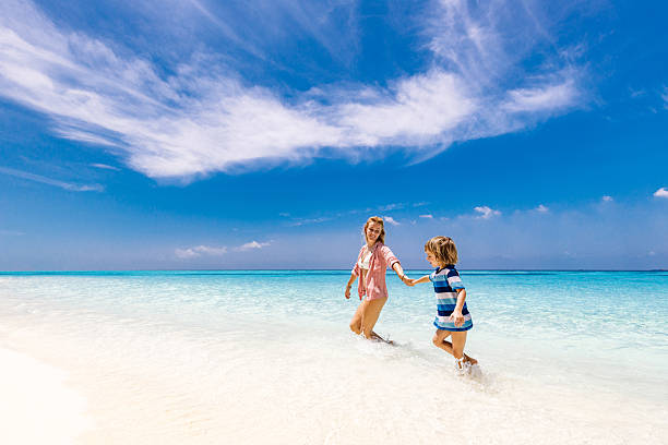 istock Happy mother and her small boy having fun at sea. 2209498310