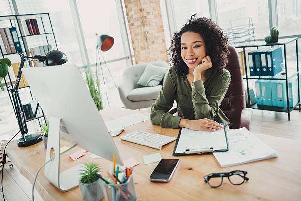 istock Confident young professional woman working in a modern office environment showcasing success and empowerment 2209504817