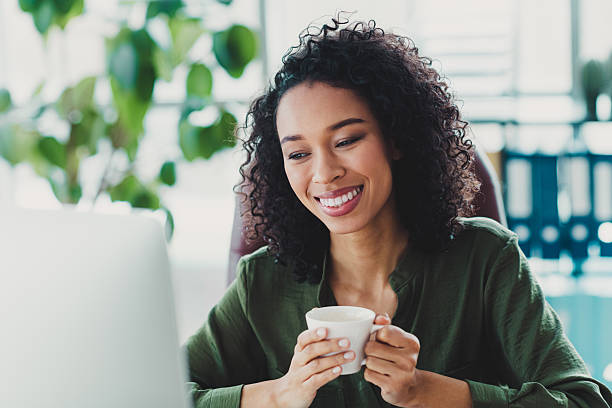 istock Young female professional enjoying coffee break in bright modern office environment 2209504940