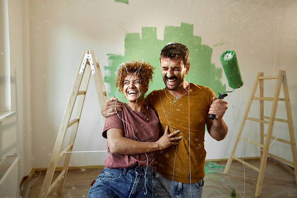 istock Cheerful couple having fun while painting their new home. 2209508206