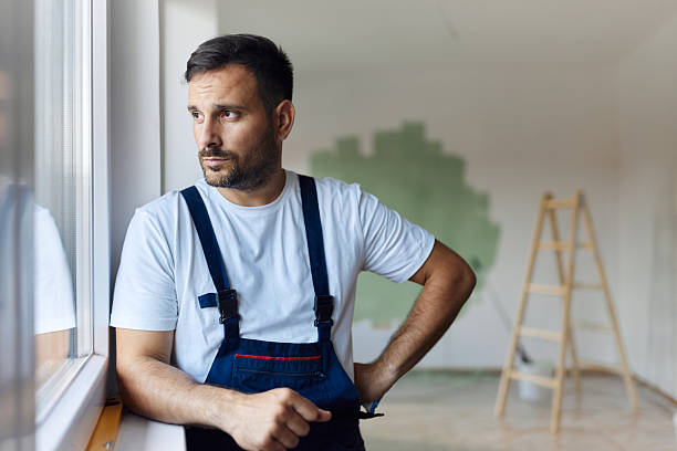 istock Thoughtful house painter by the window in the apartment. 2209508876