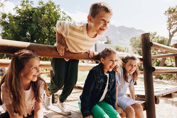 istock Group of happy children playing outdoors in a nature setting 2209509144