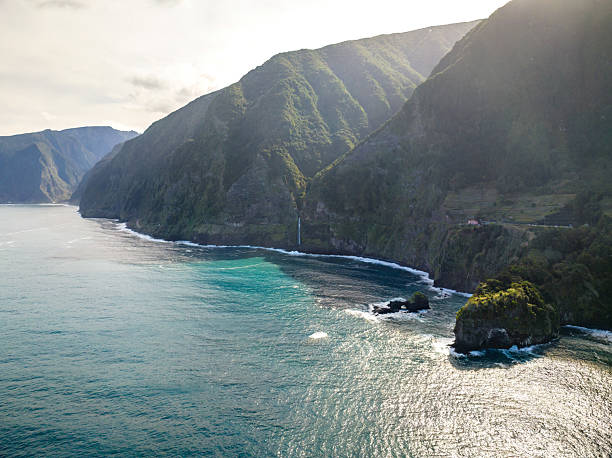 istock Bride's Veil waterfall cascading from verdant cliffs into Atlantic Ocean waters, capturing dramatic landscape of Madeira Island, Portugal under bright sunlight 2209510032