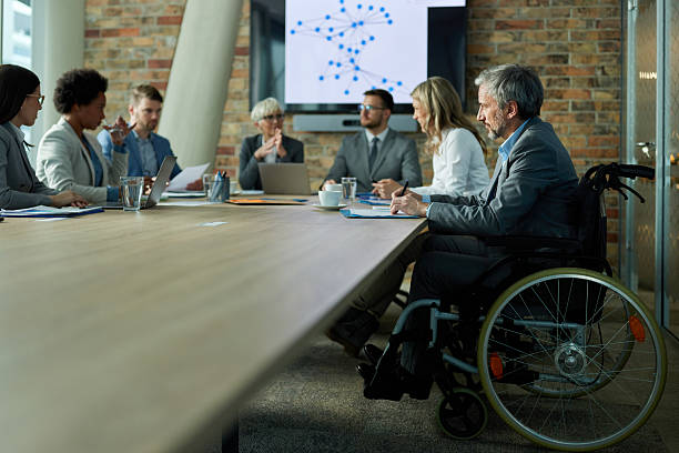 istock Disabled businessman writing plans on a meeting in the office. 2209510063