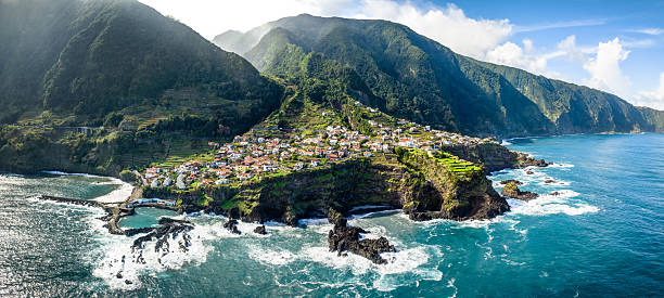 istock Charming village of Seixal, basking in warm sunlight along Madeira's rugged coastline, features traditional houses and terraced fields against the vast Atlantic Ocean 2209510986